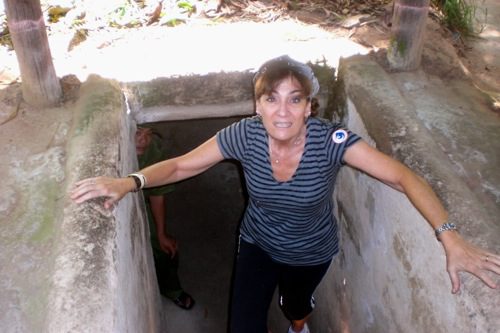 Bonnie climbing out of one of the tunnels at Cu Chi Tunnels, Vietnam © B. Miller